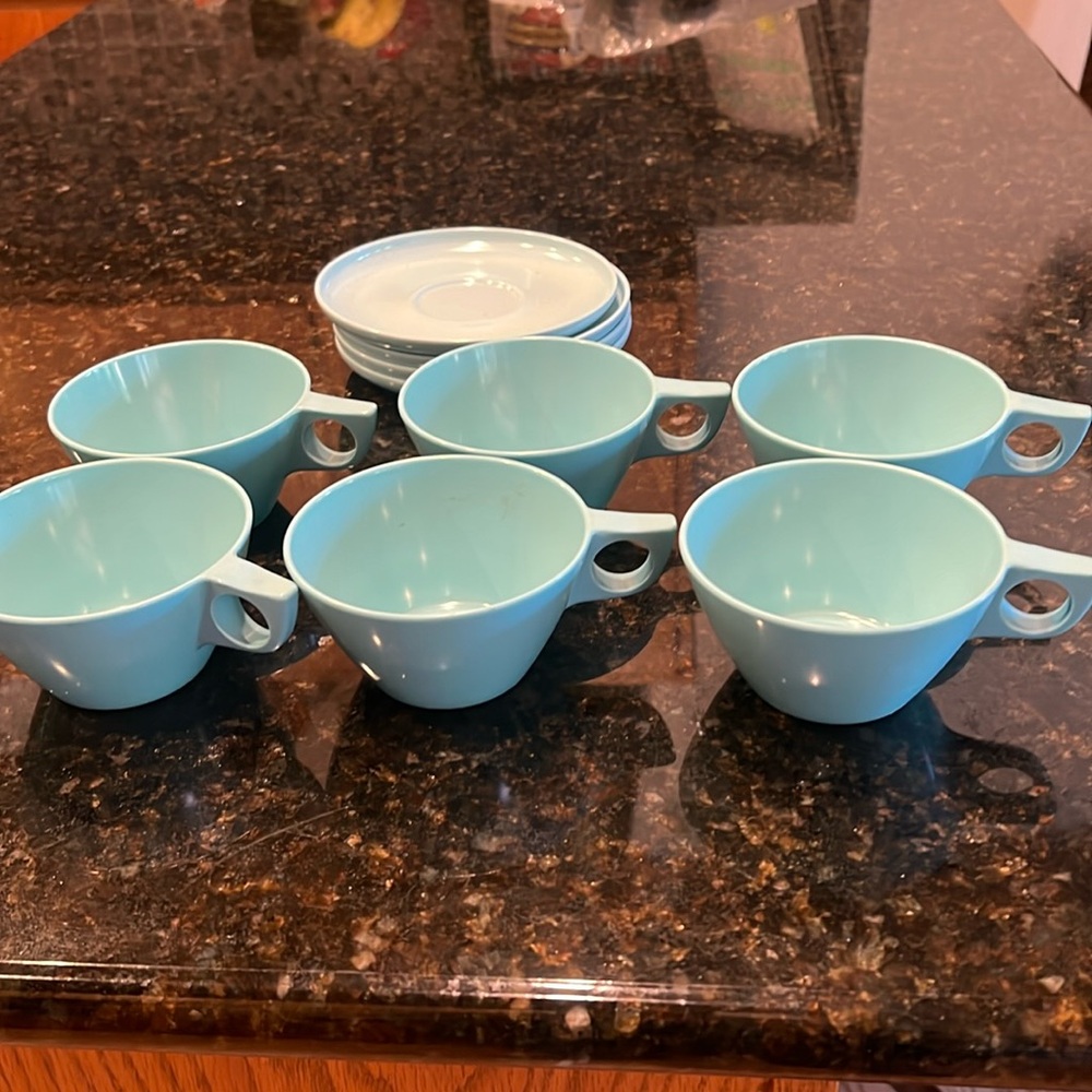 6 light blue melamine cups and 4 saucers